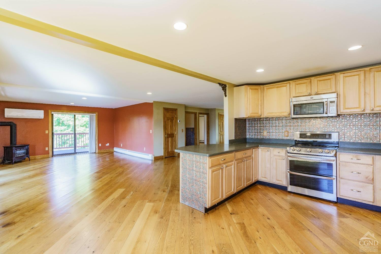 38 Cheviot Road, Unit 8 Germantown, NY 12526 - Photo 14 of 28 a large kitchen with stainless steel appliances granite countertop a stove and a wooden floors