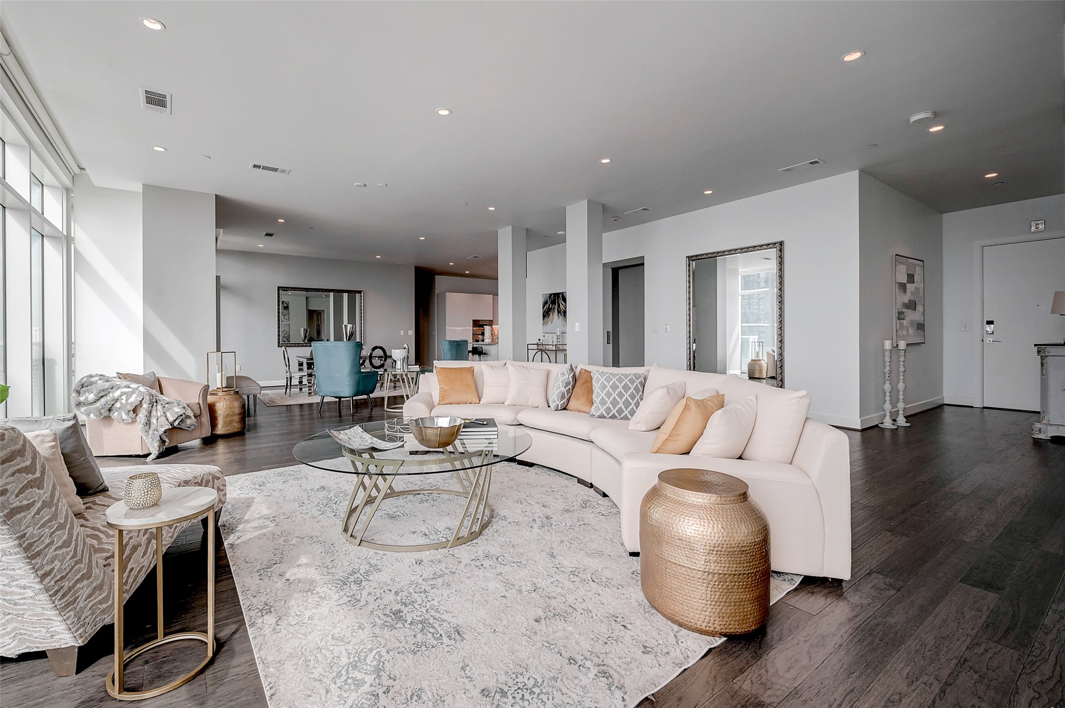a living room with furniture a wooden floor and a chandelier