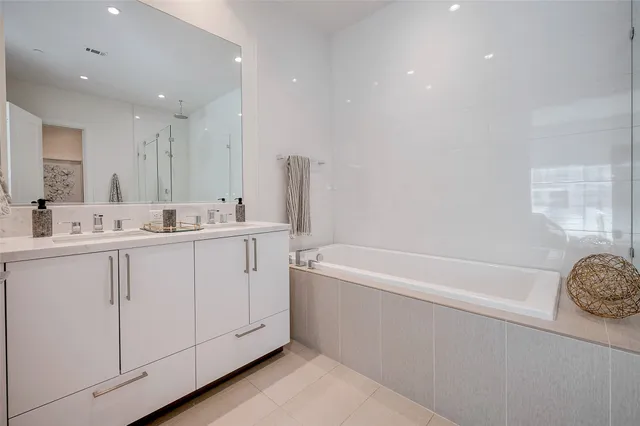 a bathroom with a sink a toilet a mirror and bathtub