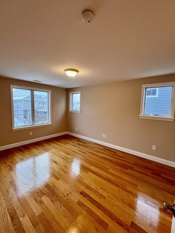 31 Rand Street, Unit 2 Revere, MA 02151 - Photo 11 of 15 a view of an empty room with window and wooden floor