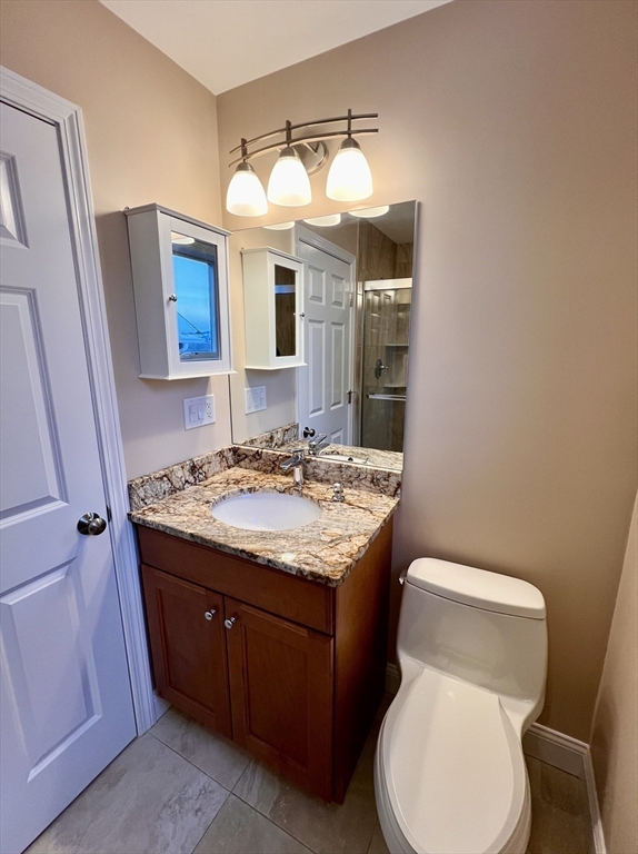 31 Rand Street, Unit 2 Revere, MA 02151 - Photo 12 of 15 a bathroom with a sink a toilet and mirror