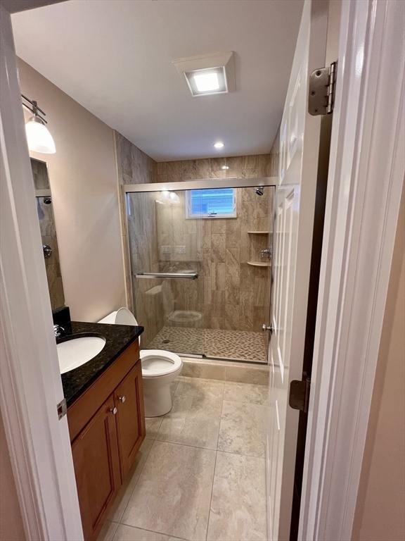 31 Rand Street, Unit 2 Revere, MA 02151 - Photo 9 of 15 a bathroom with a granite countertop sink toilet and shower