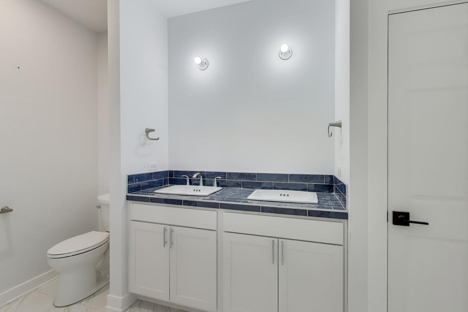894 North Quentin Road Palatine, IL 60067 - Photo 17 of 29 a bathroom with a granite countertop sink and a toilet
