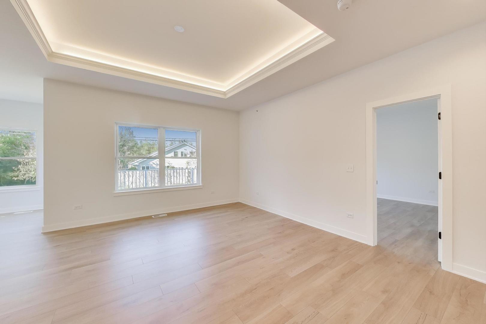 894 North Quentin Road Palatine, IL 60067 - Photo 5 of 29 an empty room with wooden floor and windows