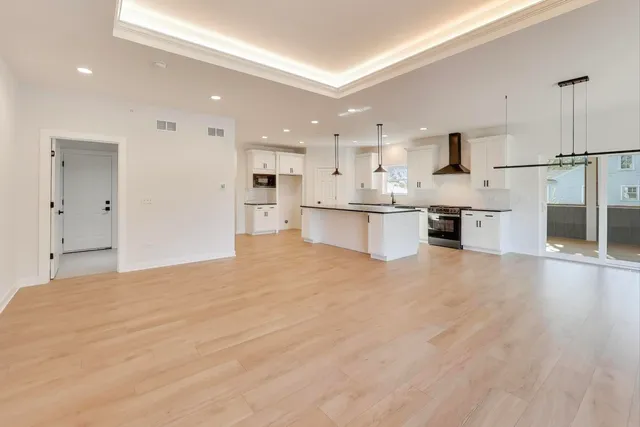 a large kitchen with a large counter top appliances and cabinets