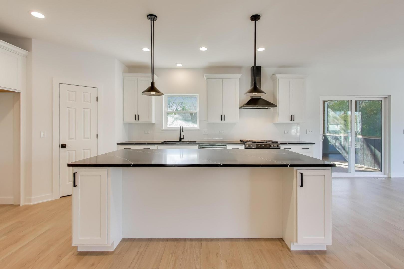 894 North Quentin Road Palatine, IL 60067 - Photo 10 of 29 a kitchen with stainless steel appliances granite countertop a sink a window and chairs