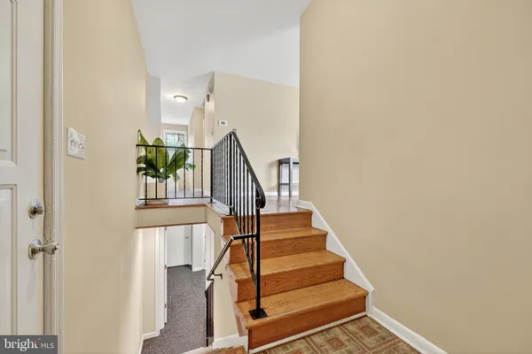 a view of entryway and hall with wooden floor