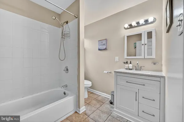 a bathroom with a tub sink toilet and a mirror