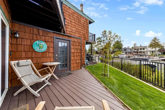 a view of a chairs and table on the wooden deck