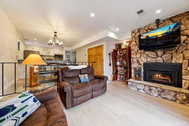 a living room with furniture and a chandelier