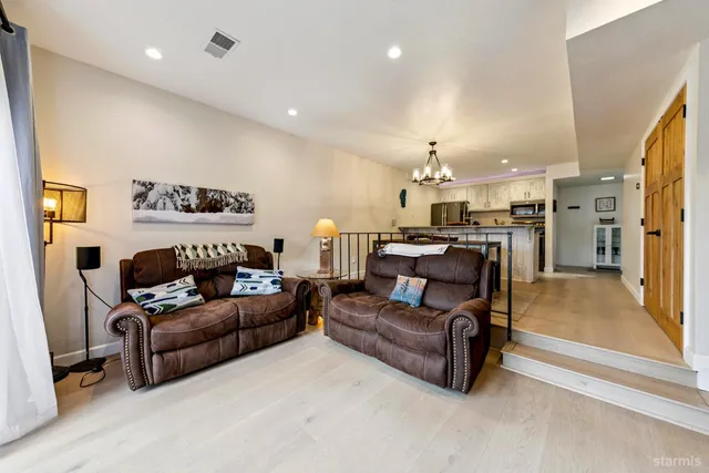 a bedroom with a bed a window and a chandelier