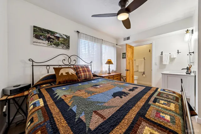a bathroom with a double vanity sink mirror and shower