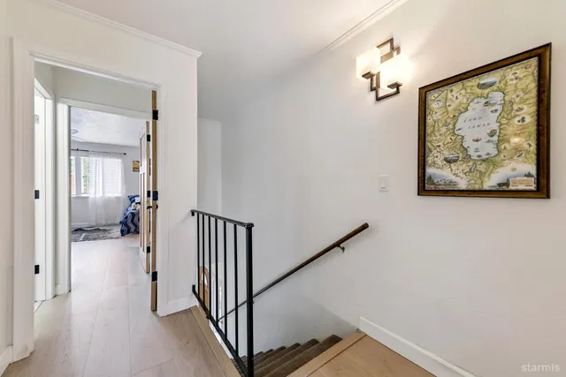 a bedroom with a bed and a painting on the wall