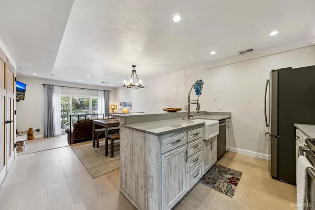 a kitchen with stainless steel appliances granite countertop a stove and a refrigerator