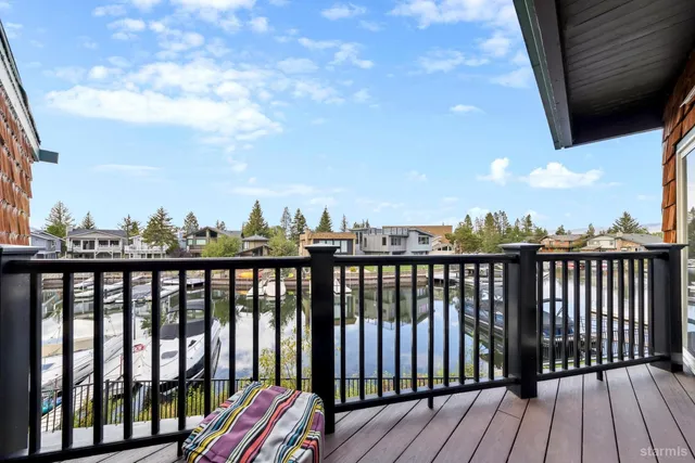 a view of a balcony with chairs and a patio