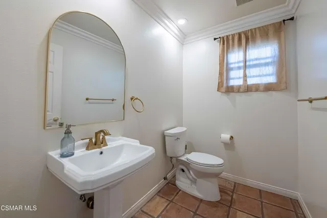 a living room with furniture a flat screen tv and a floor to ceiling window