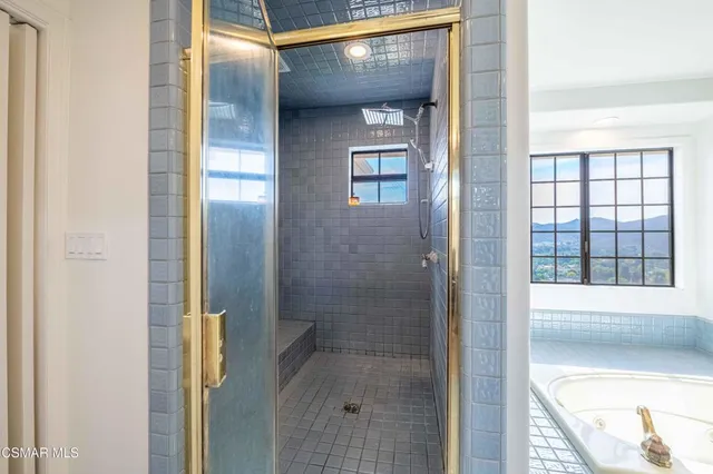 a front view of a house with a garden and lake view