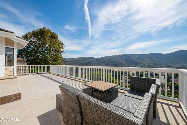 a view of a house with backyard porch and sitting area