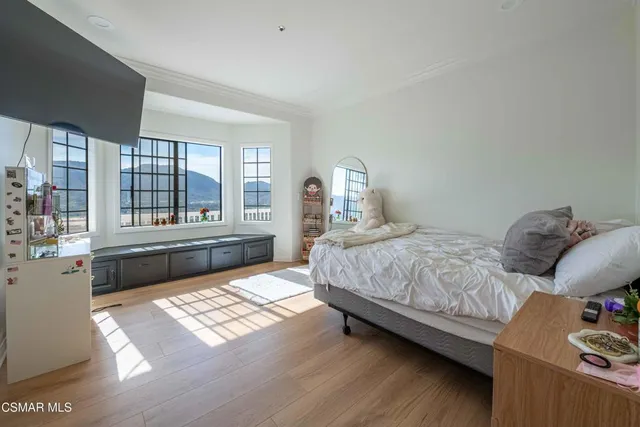 a view of a patio with a table chairs and a floor to ceiling window