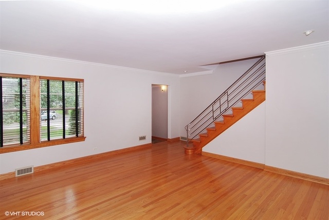 517 Berkeley Road Riverside, IL 60546 - Photo 3 of 15 a view of an empty room with wooden floor and a window