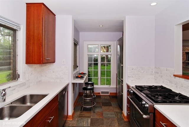 517 Berkeley Road Riverside, IL 60546 - Photo 5 of 15 a kitchen with stainless steel appliances a stove a sink and a cabinets
