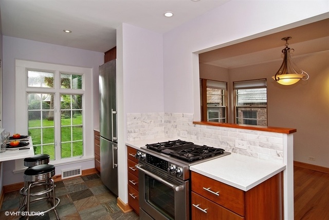 517 Berkeley Road Riverside, IL 60546 - Photo 6 of 15 a kitchen that has a stove and a view of living room