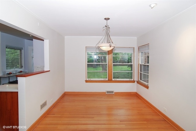 517 Berkeley Road Riverside, IL 60546 - Photo 7 of 15 a view of empty room with wooden floor and fan
