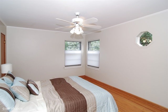 517 Berkeley Road Riverside, IL 60546 - Photo 8 of 15 a bedroom with a bed and a window