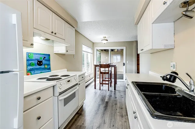 a kitchen with a stove a sink and a refrigerator