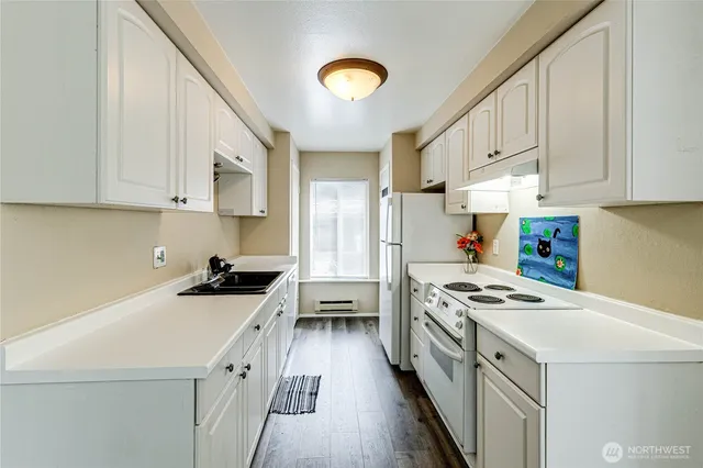 a white refrigerator freezer sitting inside of a kitchen