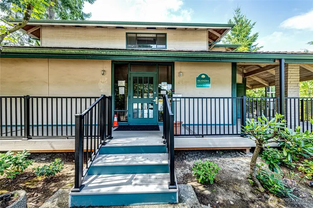 a view of a brick wall and potted plants