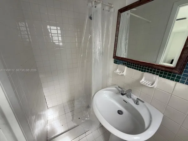 a bathroom with a sink and mirror