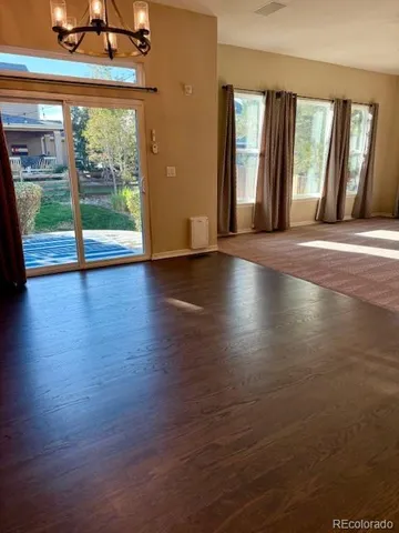 a view of room with window and wooden floor