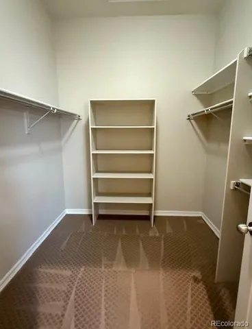 a view of room with walk in closet and closet