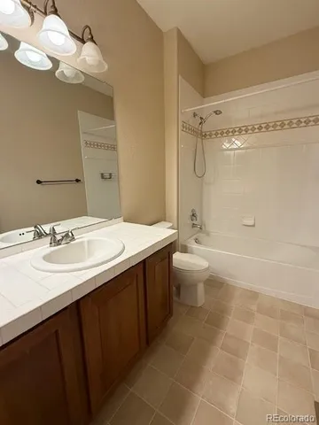 a bathroom with a double vanity sink mirror and toilet