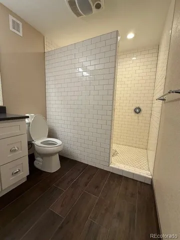 a bathroom with a toilet and a shower