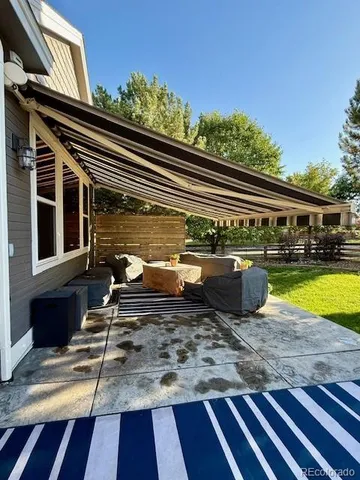 a view of a balcony with chairs and wooden floor