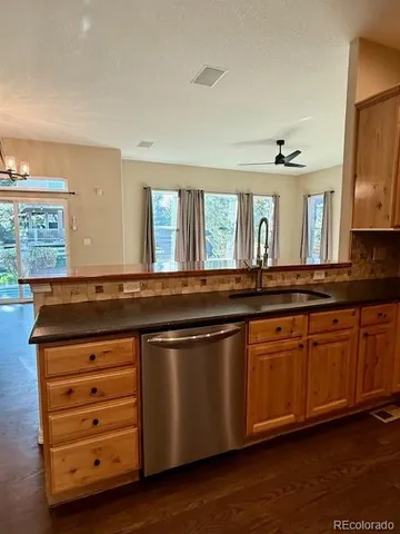 a kitchen with granite countertop a sink and cabinets