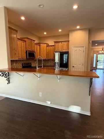 a view of kitchen with cabinets and wooden floor