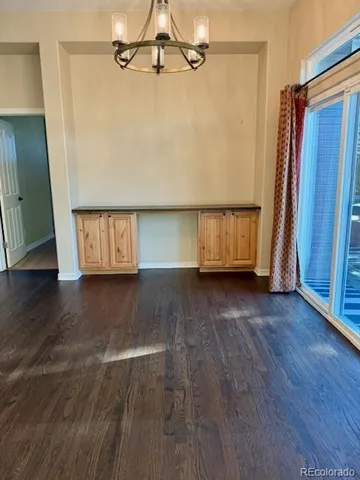 a view of a room with wooden floor