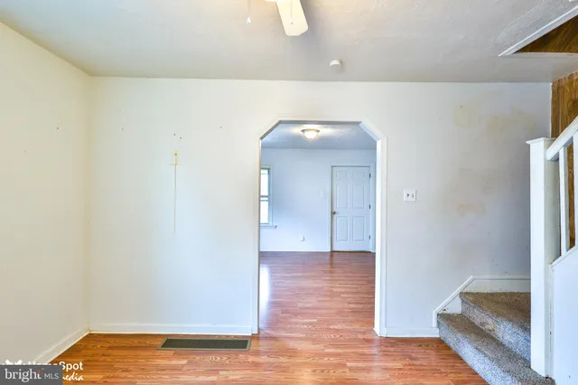 a view of a room with wooden floor