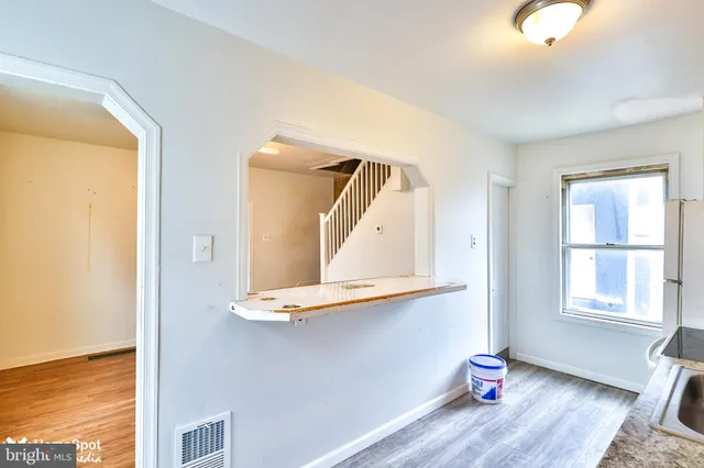 a view of a room with wooden floor and cabinet