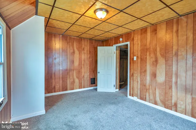 a view of a room with wooden walls
