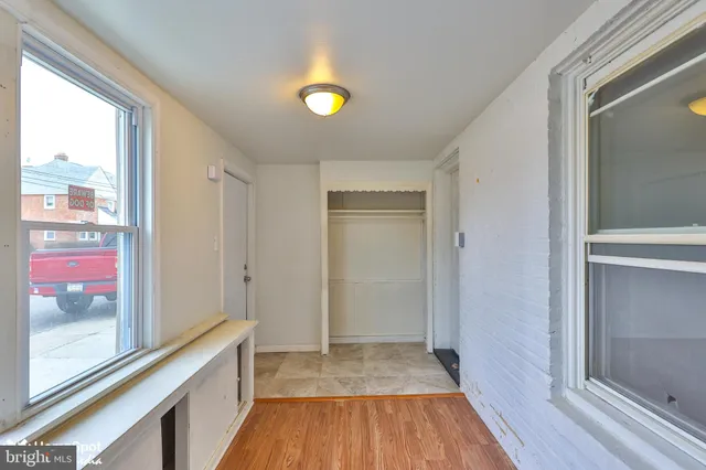a view of a room with wooden floor and window