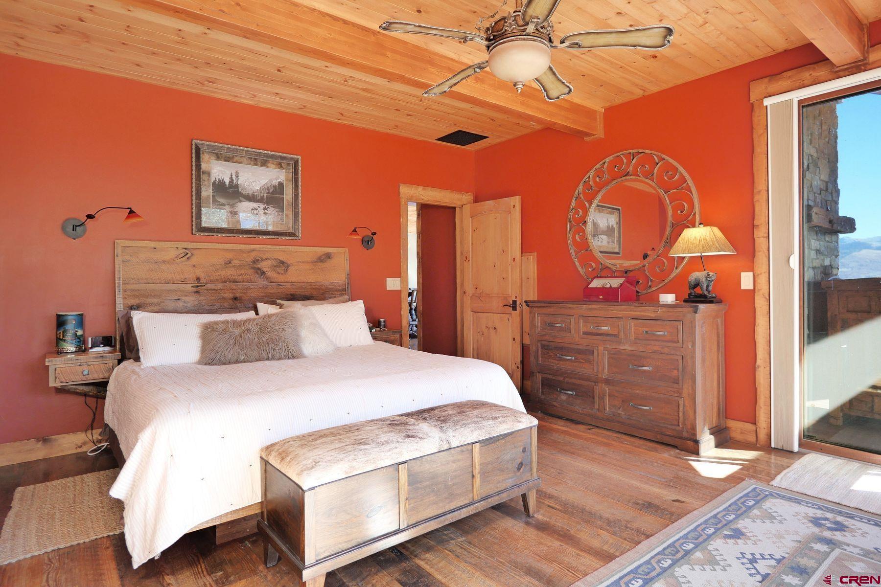 178 Valley View Road Ridgway, CO 81432 - Photo 19 of 45 a bedroom with a bed a dresser and chair