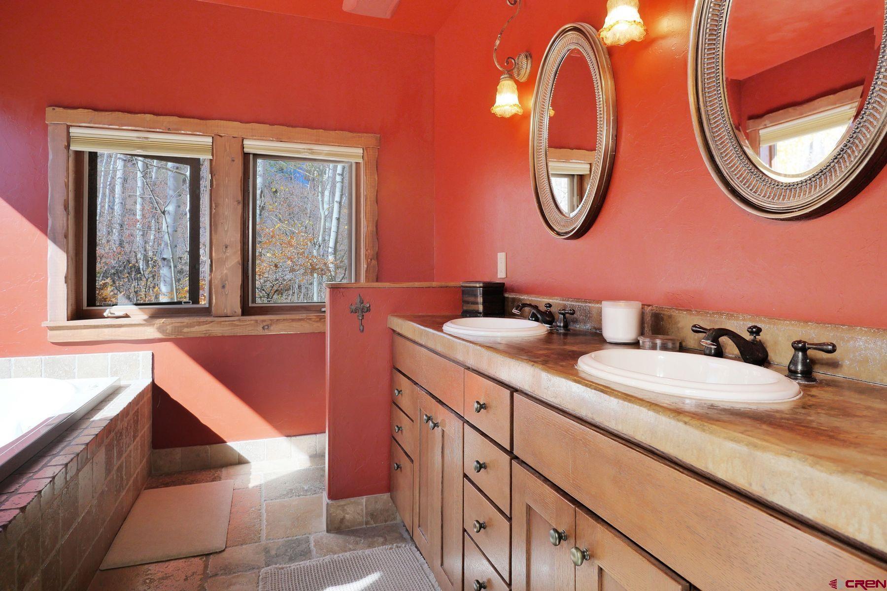 178 Valley View Road Ridgway, CO 81432 - Photo 20 of 45 a bathroom with a granite countertop toilet a sink and a mirror