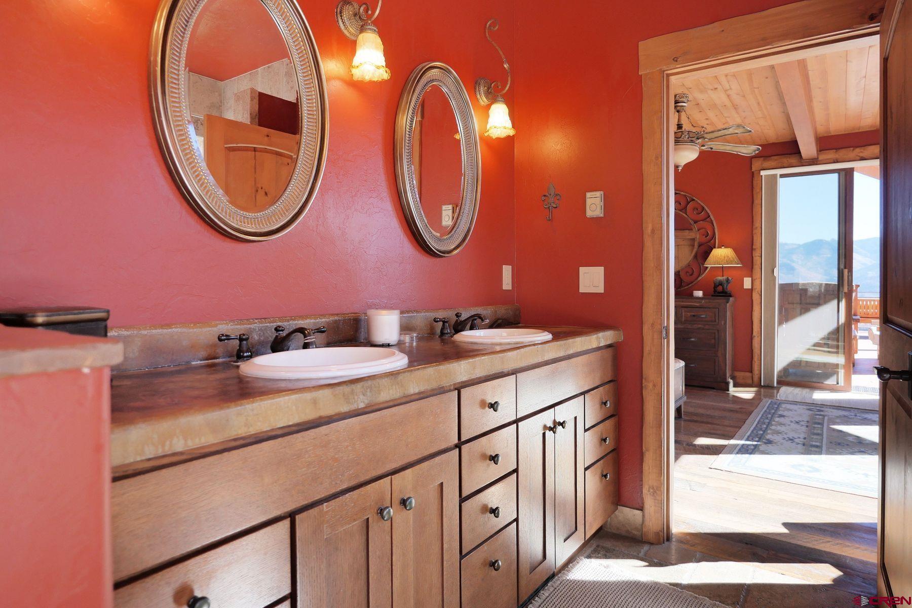178 Valley View Road Ridgway, CO 81432 - Photo 22 of 45 a bathroom with a granite countertop double vanity and a mirror