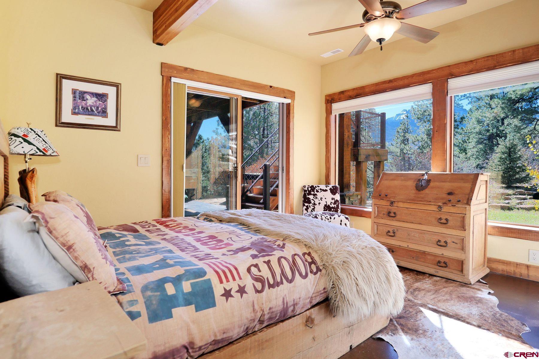 178 Valley View Road Ridgway, CO 81432 - Photo 23 of 45 a bedroom with a large bed and a window