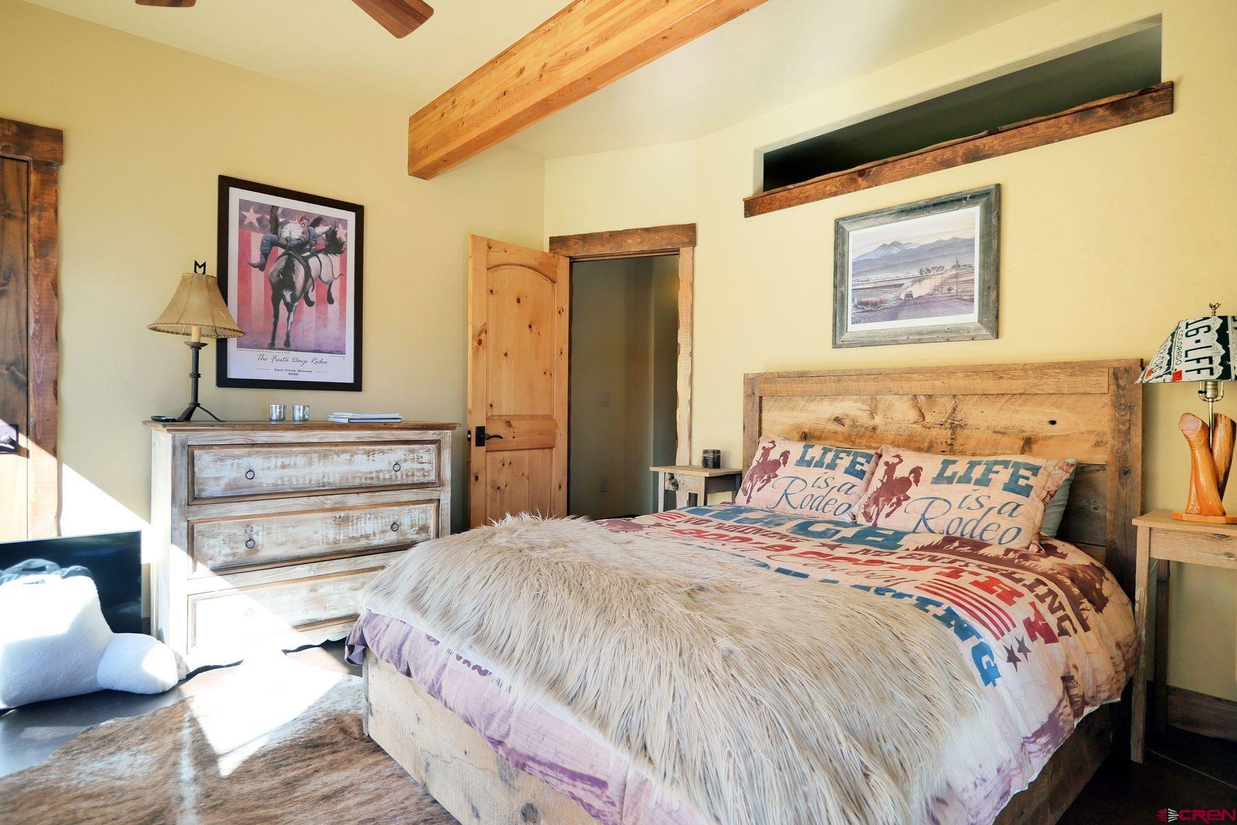 178 Valley View Road Ridgway, CO 81432 - Photo 24 of 45 a bedroom with a bed and a painting on the wall