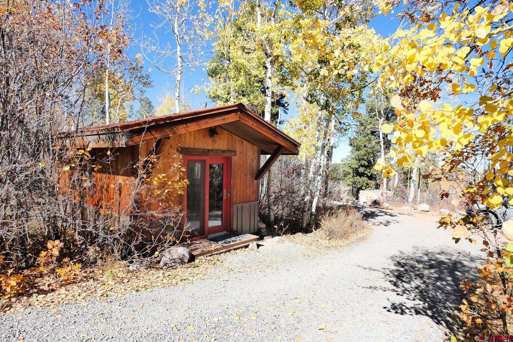 178 Valley View Road Ridgway, CO 81432 - Photo 34 of 45 a view of a house with a tree covered in snow